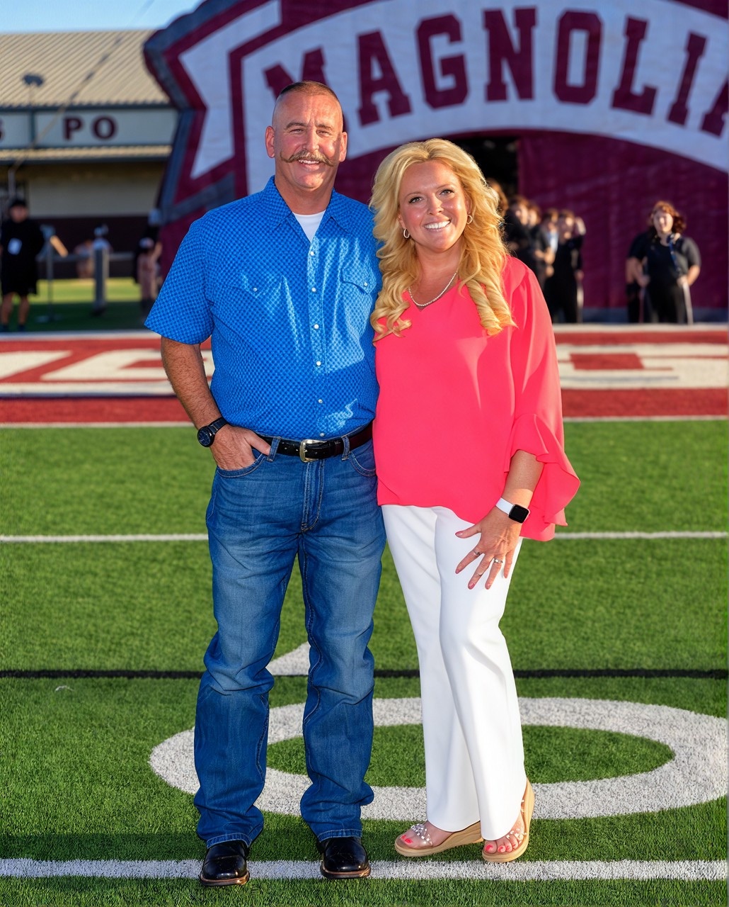 Co-founders Claire and Tom Richardson on the field at a Magnolia football game