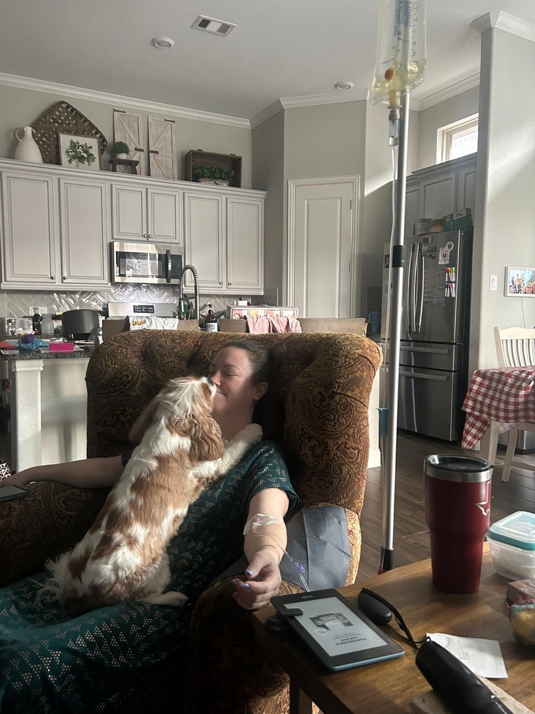 A client resting in her armchair with her dog during an in-home IV