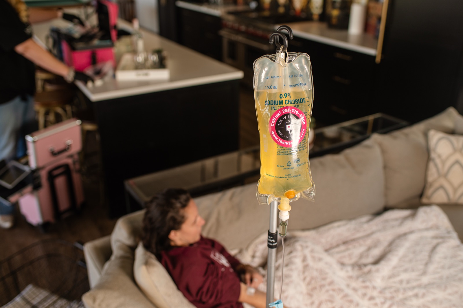 A client resting on the couch during an in-home IV