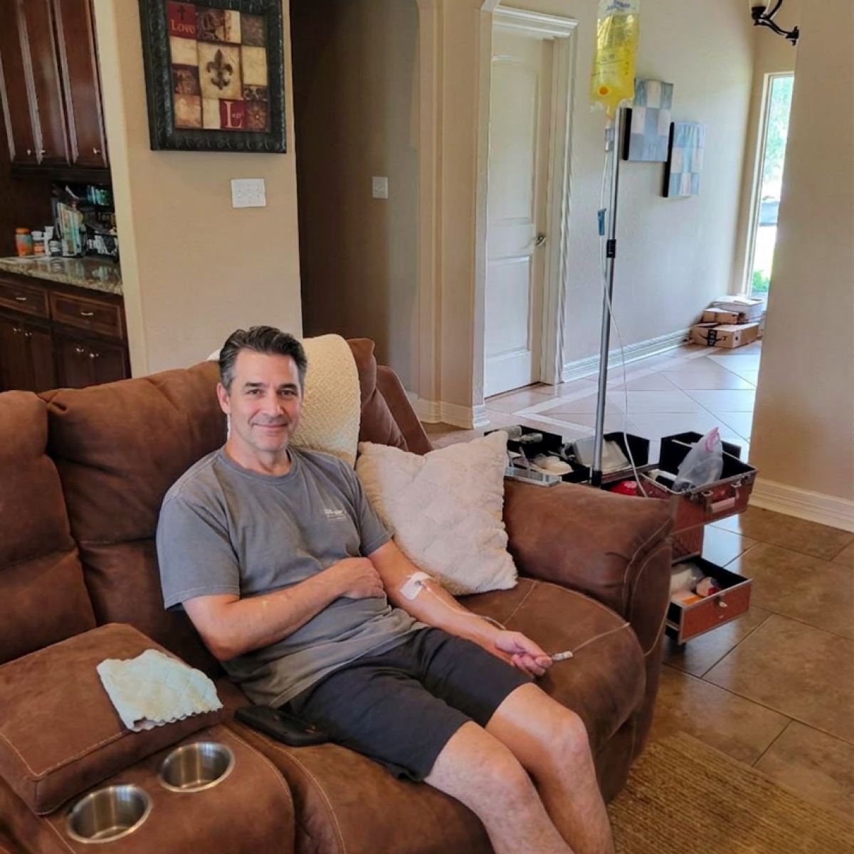 A client resting on his couch during an in-home IV