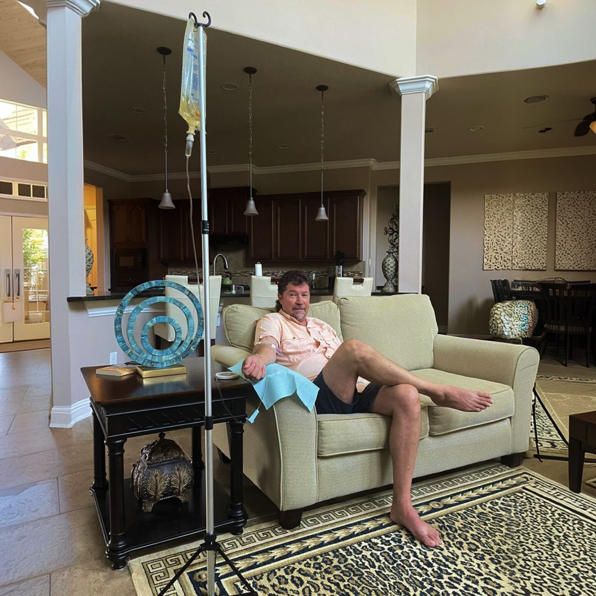 A client stretched out on his sofa during an in-home IV