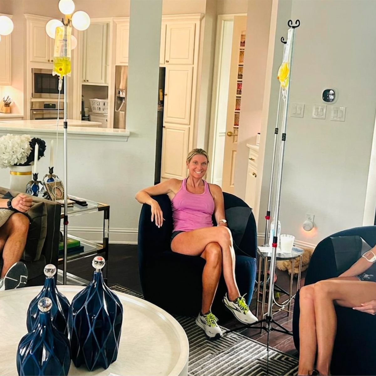 A client in workout clothes relaxing in a chair during an IV
