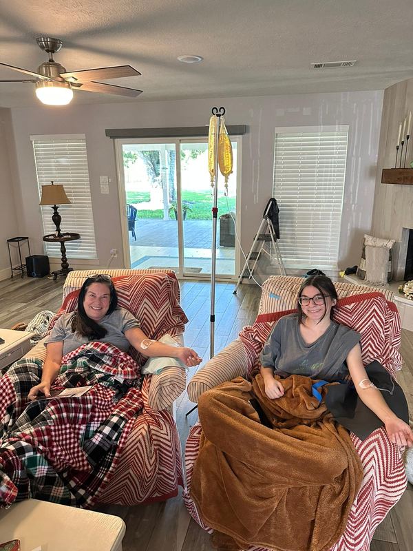 Two clients wrapped in blankets in armchairs during their IVs