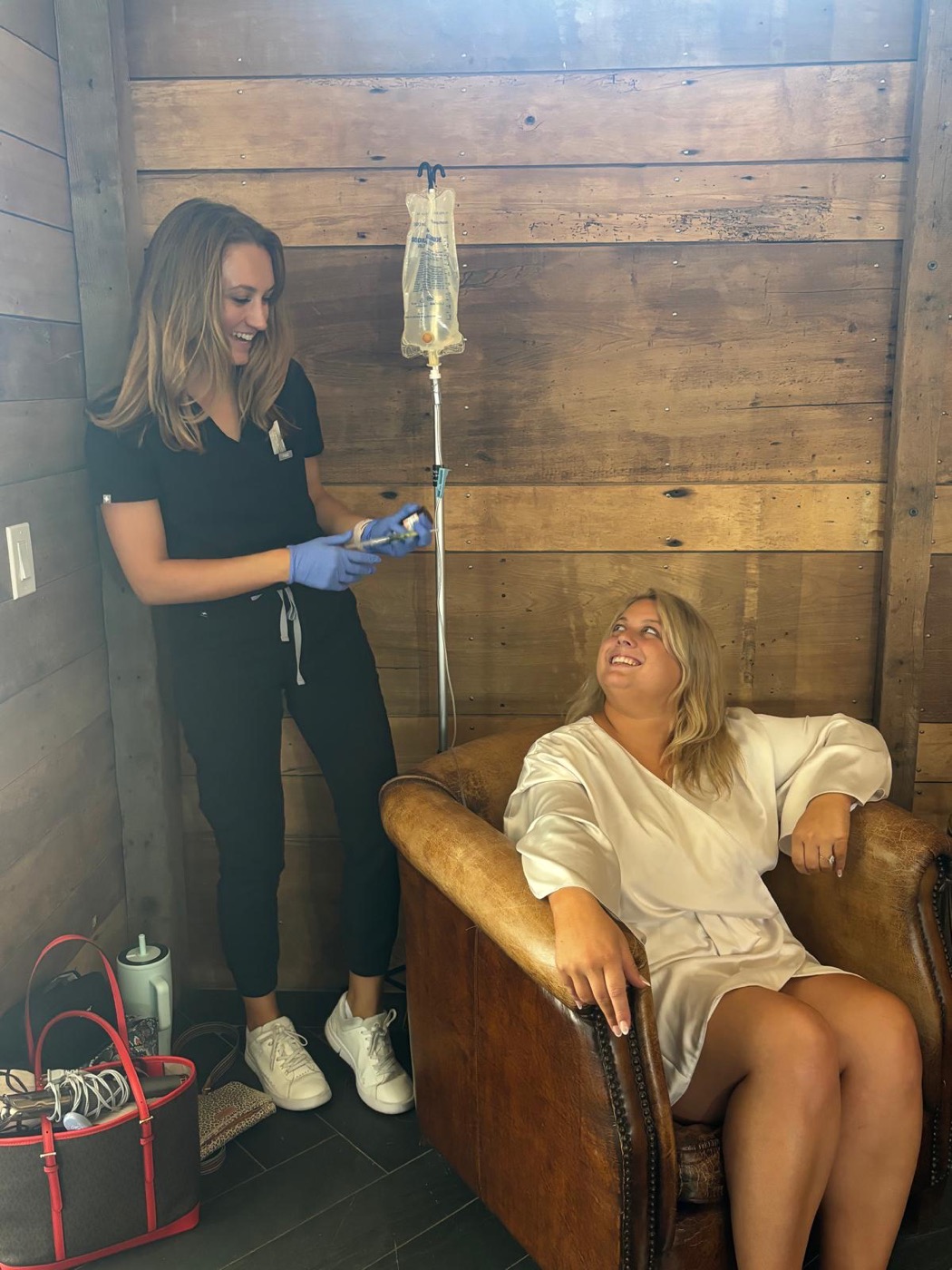 A provider setting up an IV for a client at home